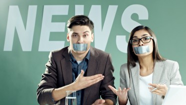 News presenters with taped mouths on TV